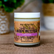 Jar of lavender body butter with a label on a wooden surface.