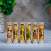 Set of lip balms with labels on a neutral background