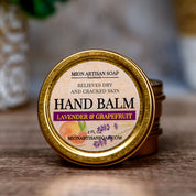 Hand balm container with lavender and grapefruit scent on a wooden surface