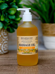 Bottle of Mion Artisan Soap massage oil on a wooden surface with plants in the background